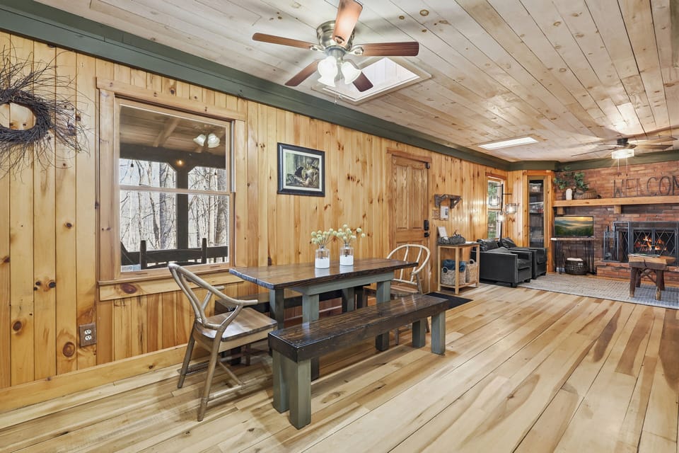 Dining area with mountain views and fireplace glow nearby