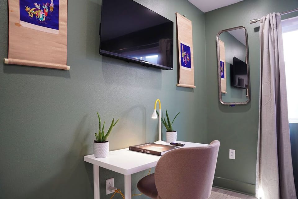 Cozy dedicated workspace with a sleek white desk and comfortable padded chair.