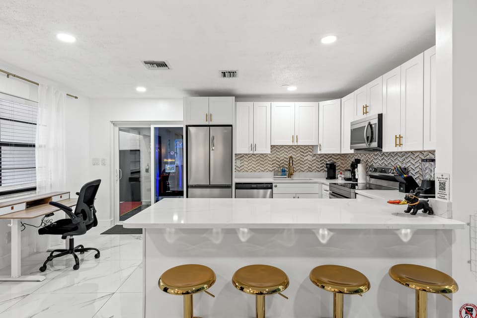 Bright, modern kitchen with a spacious island and bar seating—perfect for group meals and easy mornings.