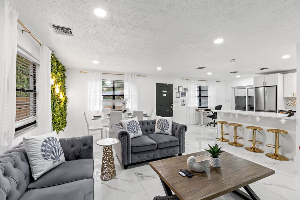 Bright living room with plush seating, a large Smart TV, and a cozy fireplace for laid-back nights in.