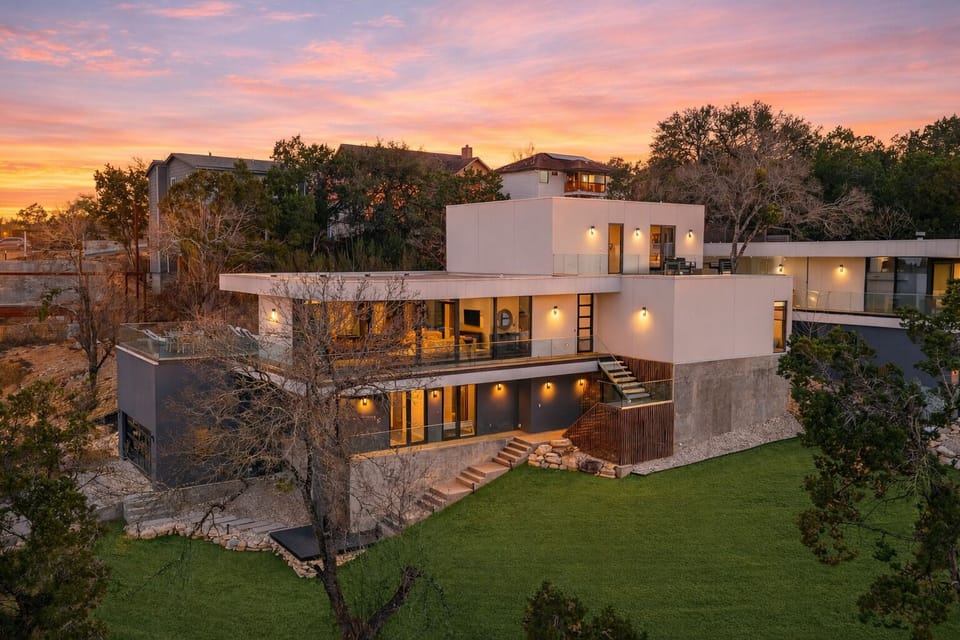 Striking modern Austin retreat with floor-to-ceiling glass and hillside views.