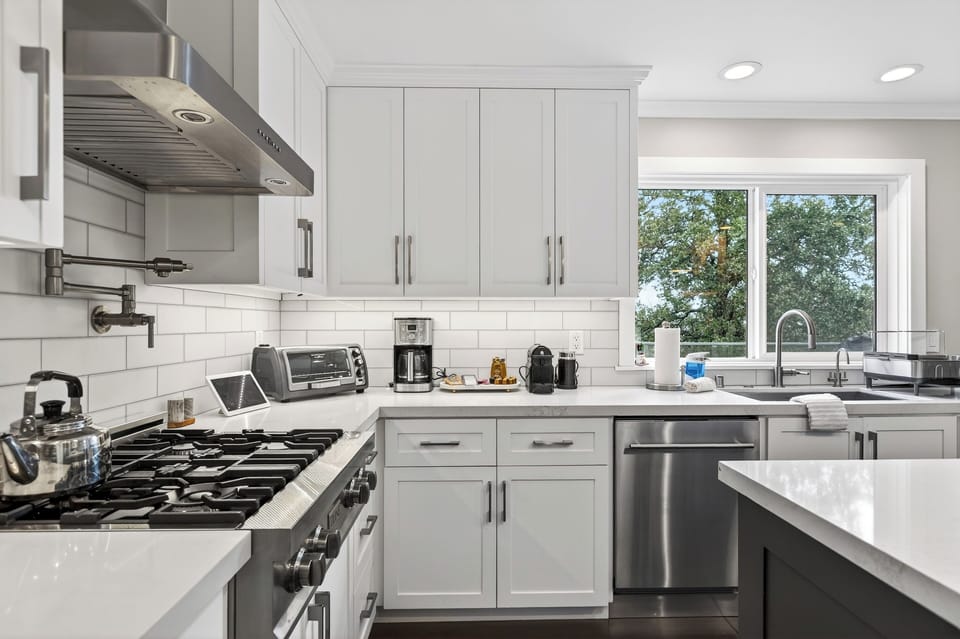 Functional kitchen workspace with white cabinetry and subway tile backsplash.