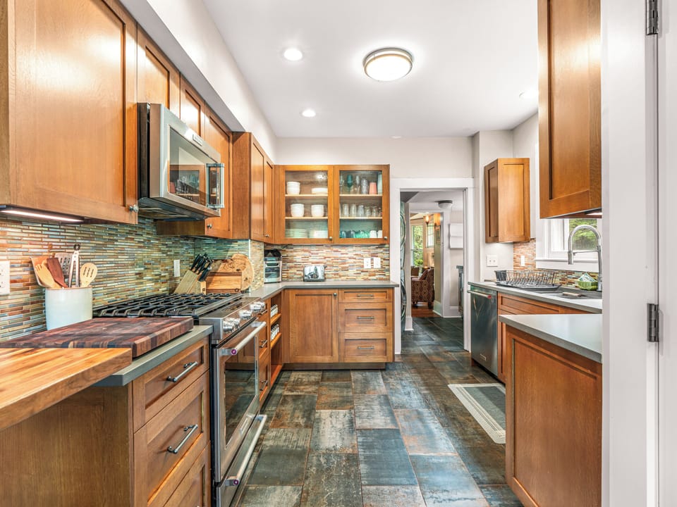 Bright updated kitchen with stainless appliances and warm wood finishes