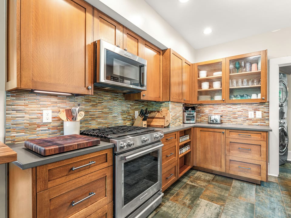 Stylish chef’s kitchen with warm wood finishes and stainless appliances