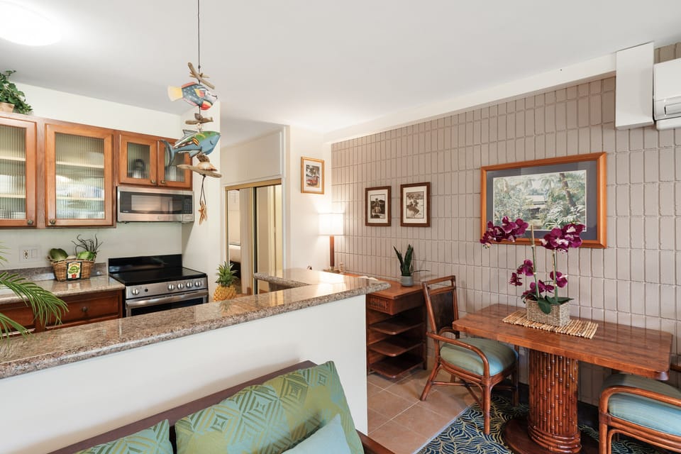 Kitchen and dining area with breakfast bar seating and open layout.