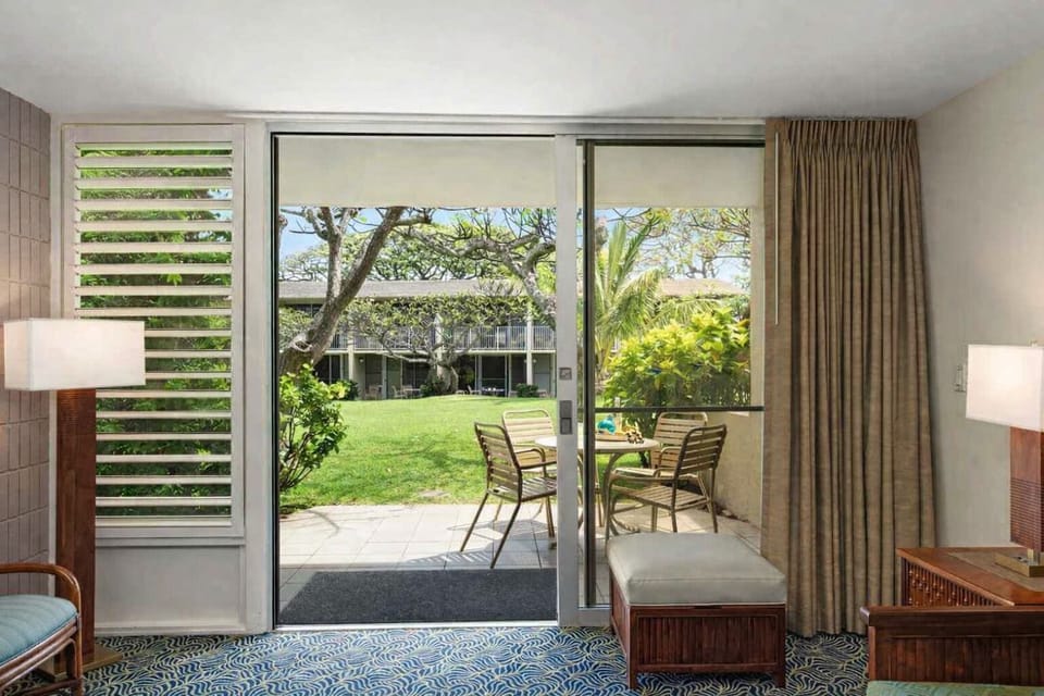 Bright living area with sliding doors opening to the furnished garden lanai.