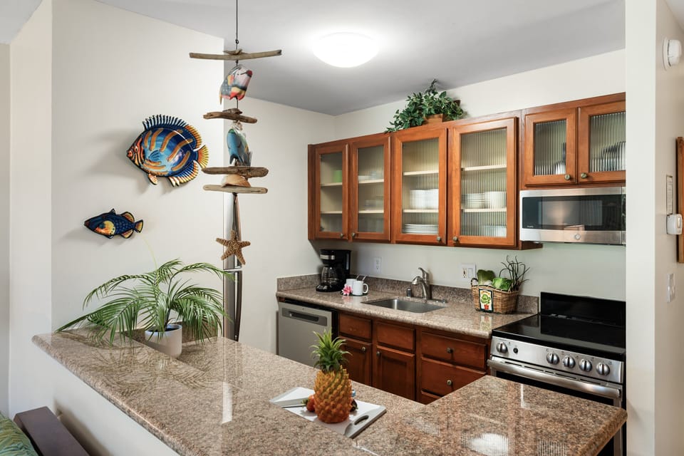 Fully equipped kitchen with granite counters and bright island touches.