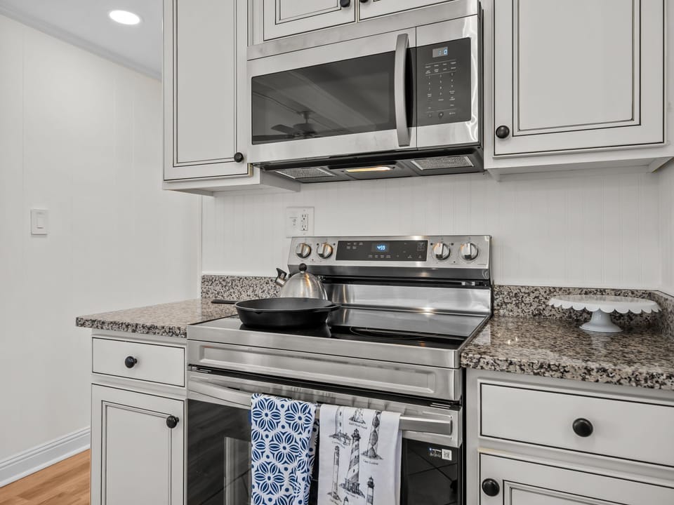 Cook with ease in your fully-equipped kitchen, featuring granite counters, stainless steel appliances, and all the cookware you need.