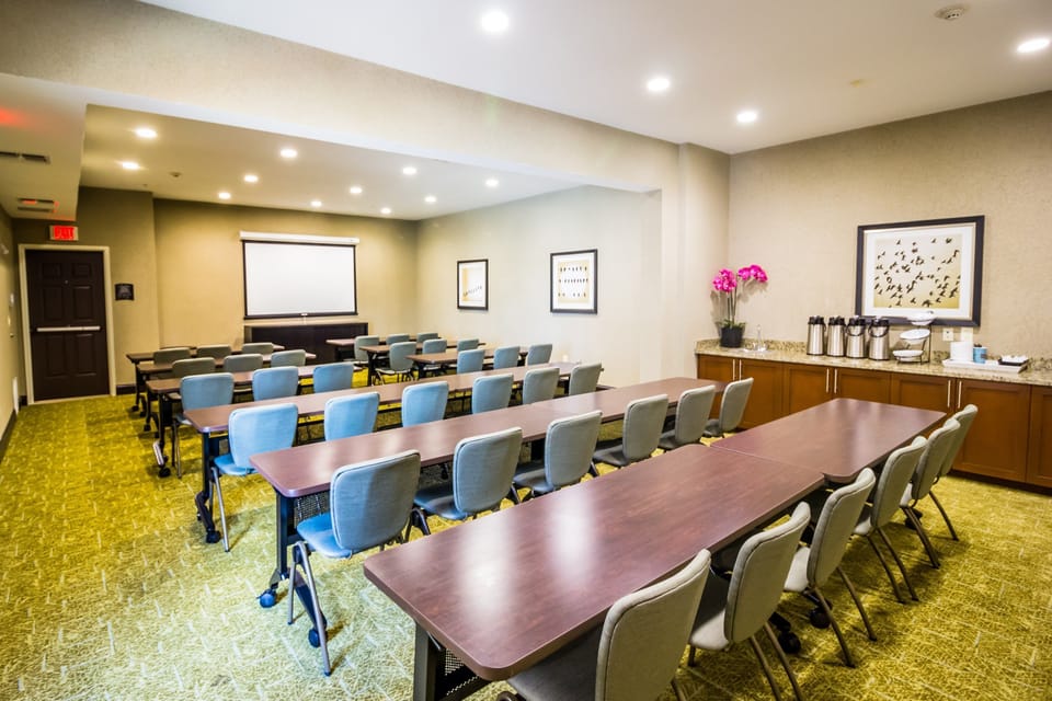 Conference room with tables and chairs for meetings.