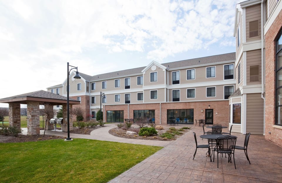 Landscaped courtyard with manicured lawn and stone seating area.