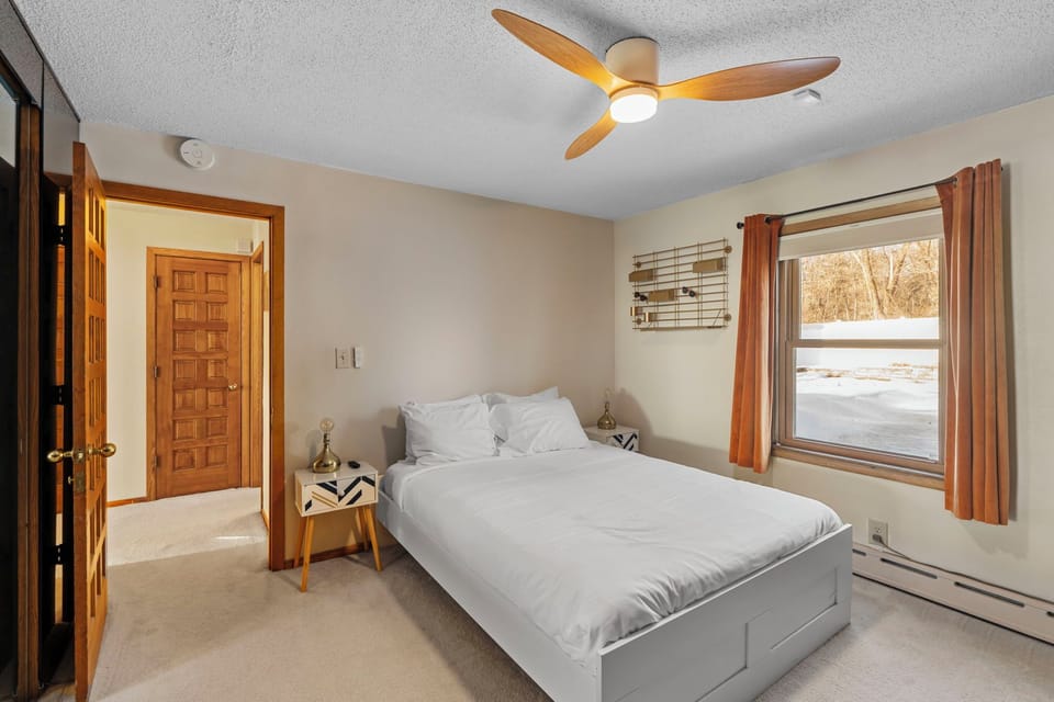 Wake up refreshed in your serene bedroom, where crisp linens and a gentle ceiling fan create the perfect sleeping sanctuary.