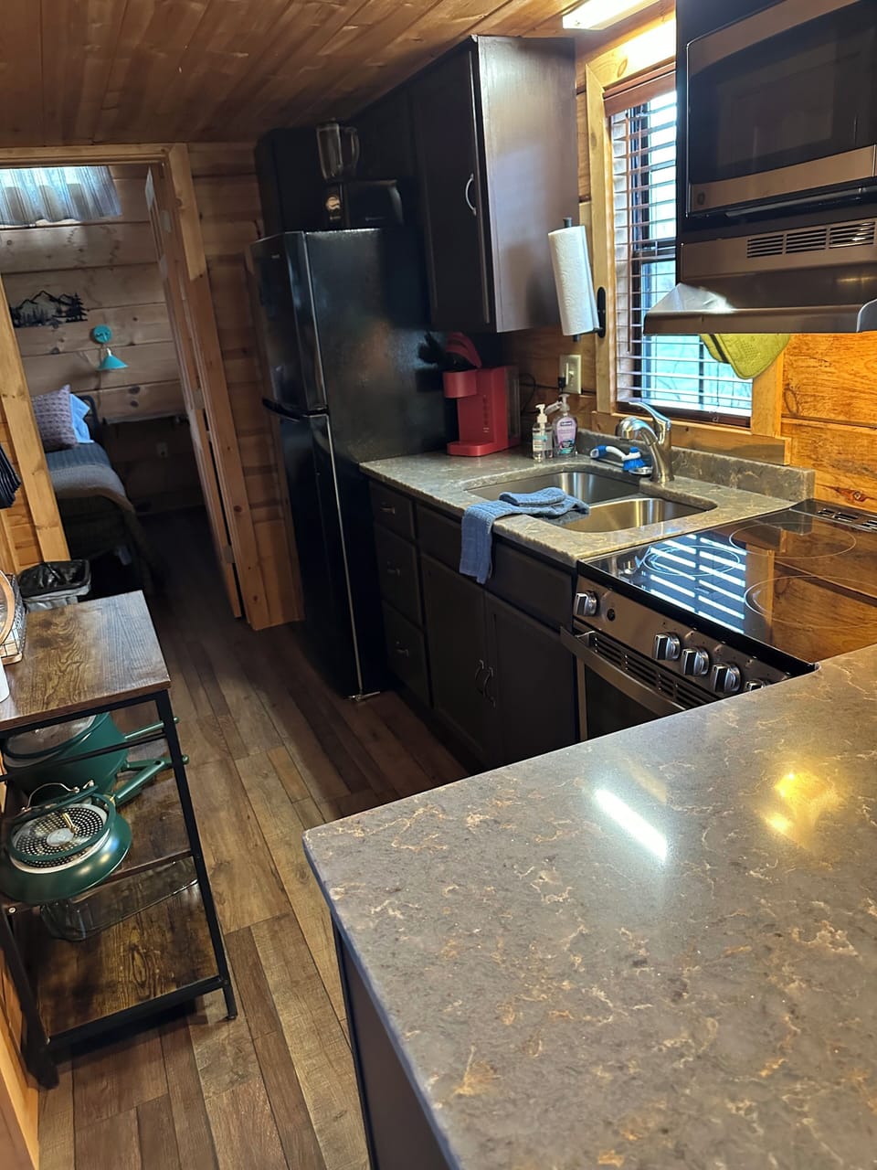 Kitchen area with full fridge, microwave, dishwasher, oven/stove