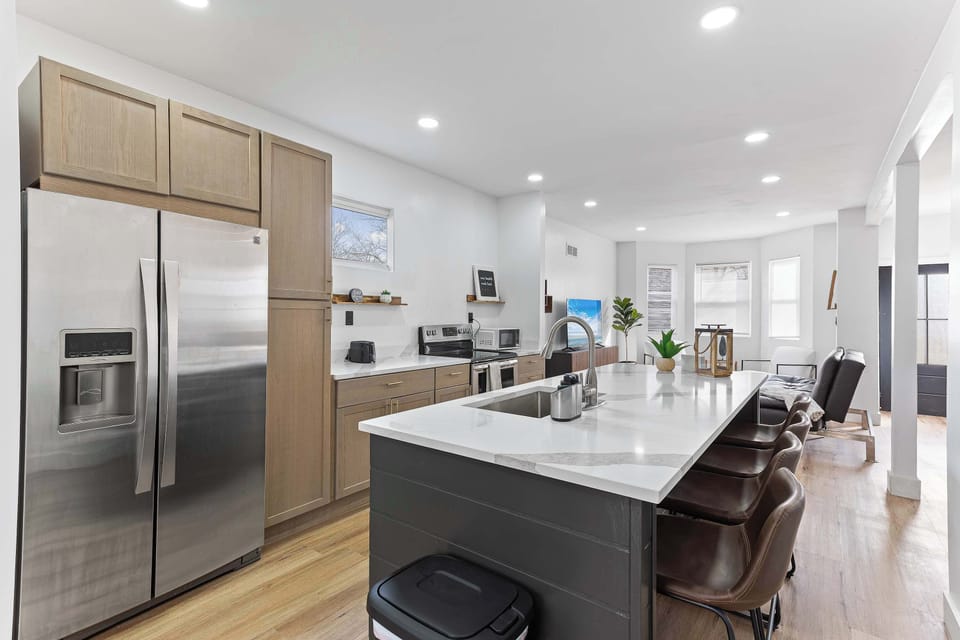 Modern kitchen with a large island, stainless steel appliances, and generous prep space. Ideal for cooking, casual dining, and gathering comfortably with family or friends.