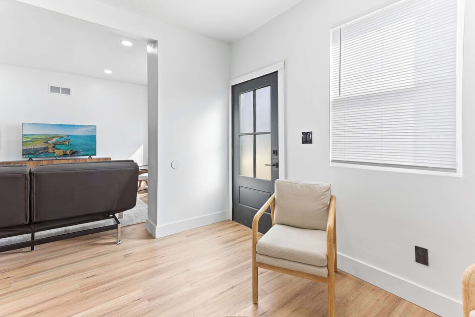 Comfortable living area with clean modern design and warm natural light. A calm and inviting space for reading, relaxing, or unwinding after a busy day.