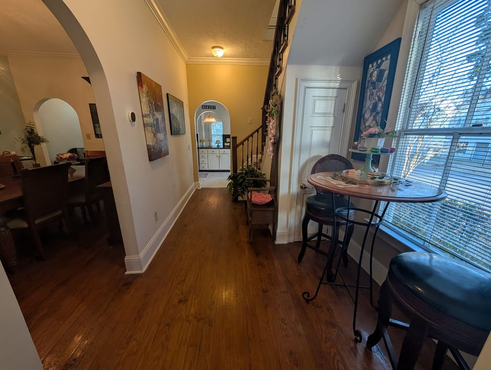 hall way with cute coffee table with window views