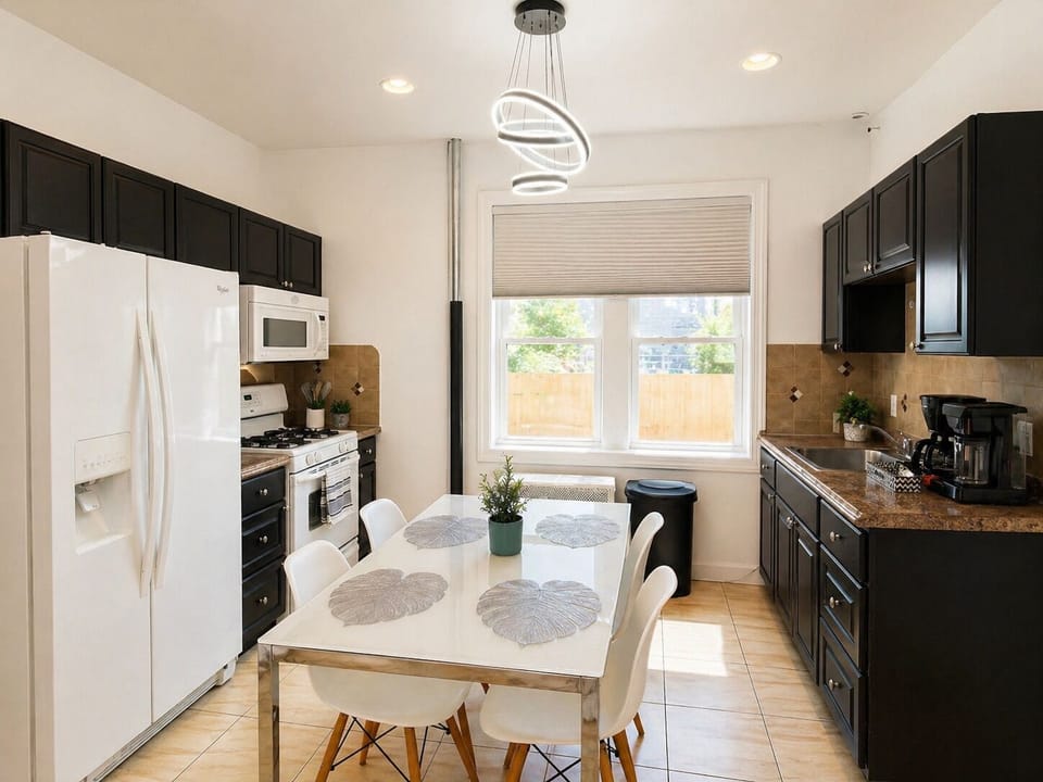 Bright eat-in kitchen with coffee bar, gas range, and seating for six.
