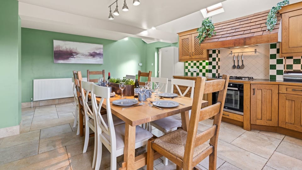 Wrap-around wooden units and green checkerboard tiling give a quirky touch to this traditional room.
