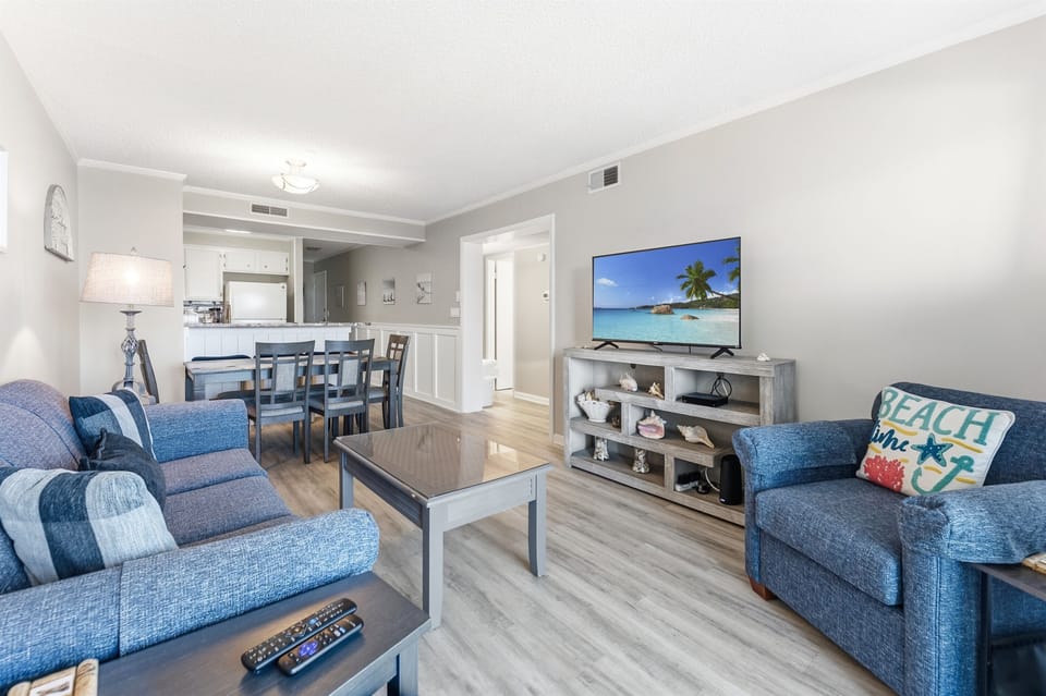 Spacious Living room with seating for everyone and balcony access