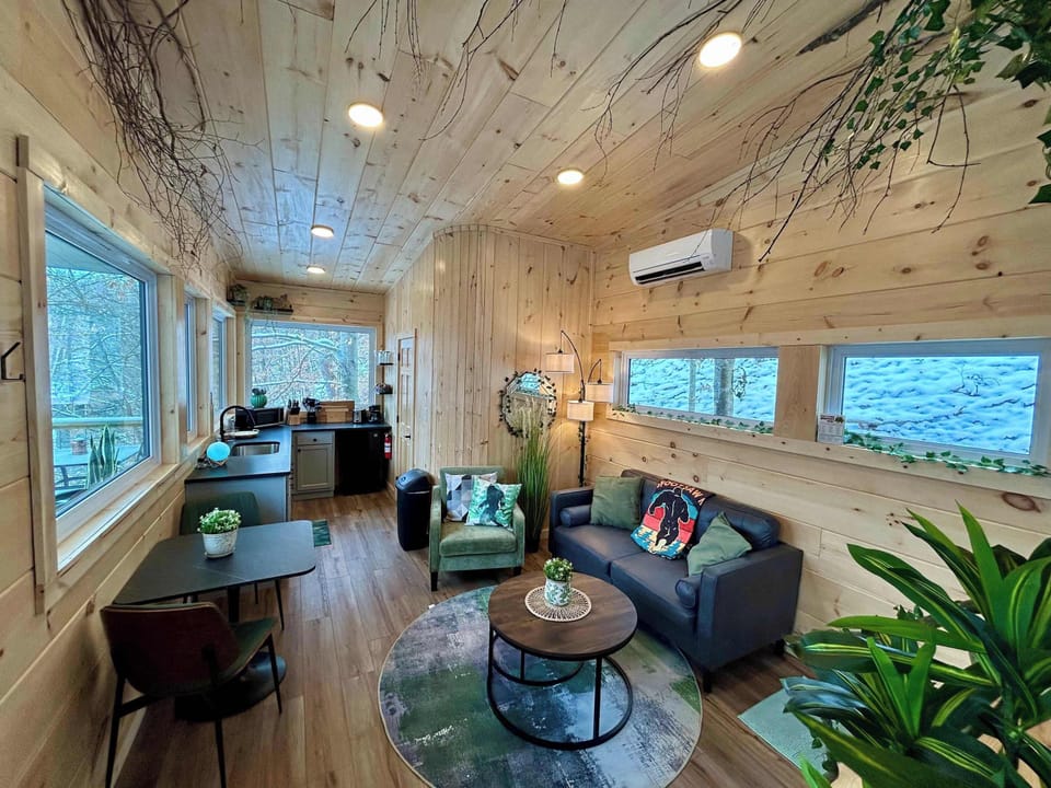 Walk inside to a warm, open living space that flows into a bright kitchen lined with windows. Whether you’re making breakfast before a day of adventure or winding down after exploring the Gorge, this cabin is your place to get away.