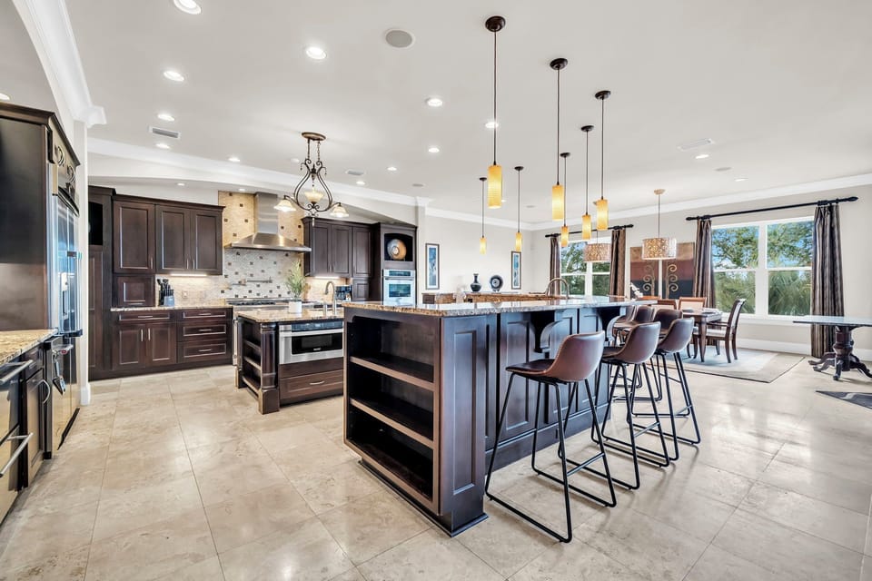The spacious chef’s kitchen anchored by an oversized island with generous seating for gathering.
