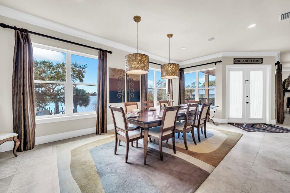Gather around this elegant dining table where bay views create the perfect backdrop for memorable meals together.