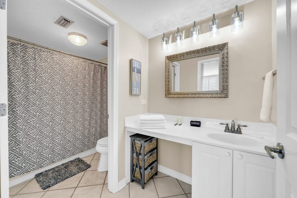 Refresh in your beautifully appointed master bathroom featuring elegant tile work, premium vanity lighting, and plush towels waiting for your arrival.