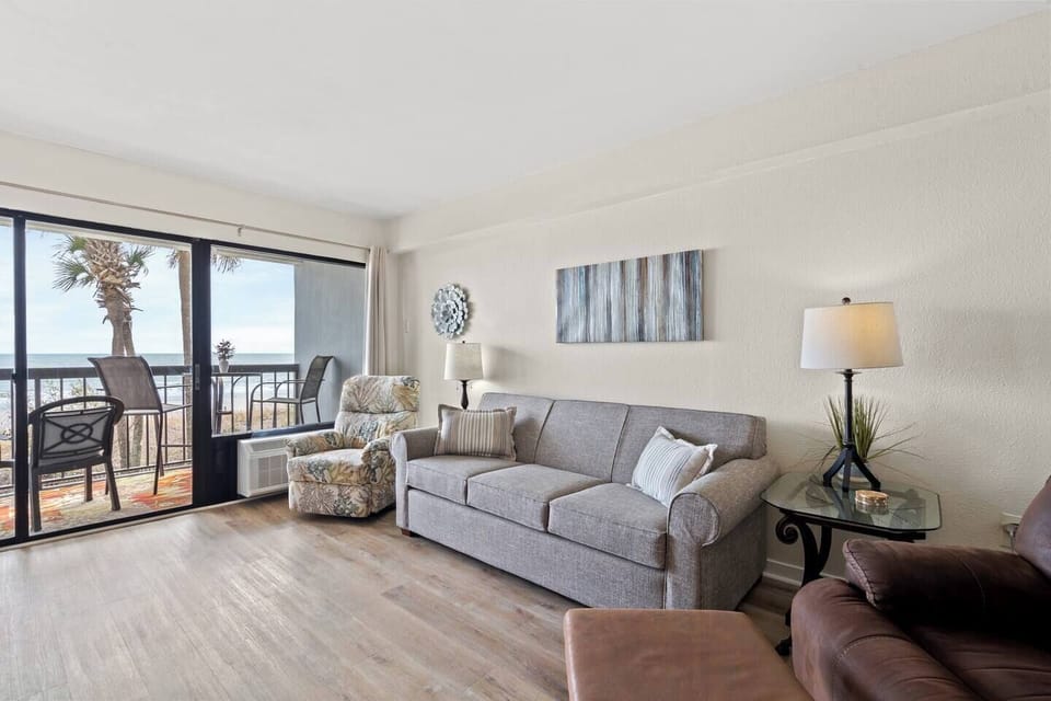 Coastal-inspired seating area with a comfortable sofa and two inviting recliners, styled for relaxation.