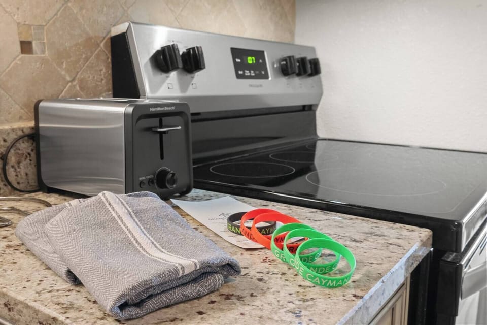 Modern, fully stocked kitchen designed for convenience, featuring clean finishes, essential cookware, dishware, and appliances; perfect for preparing meals, snacks, or coffee during your Myrtle Beach stay.