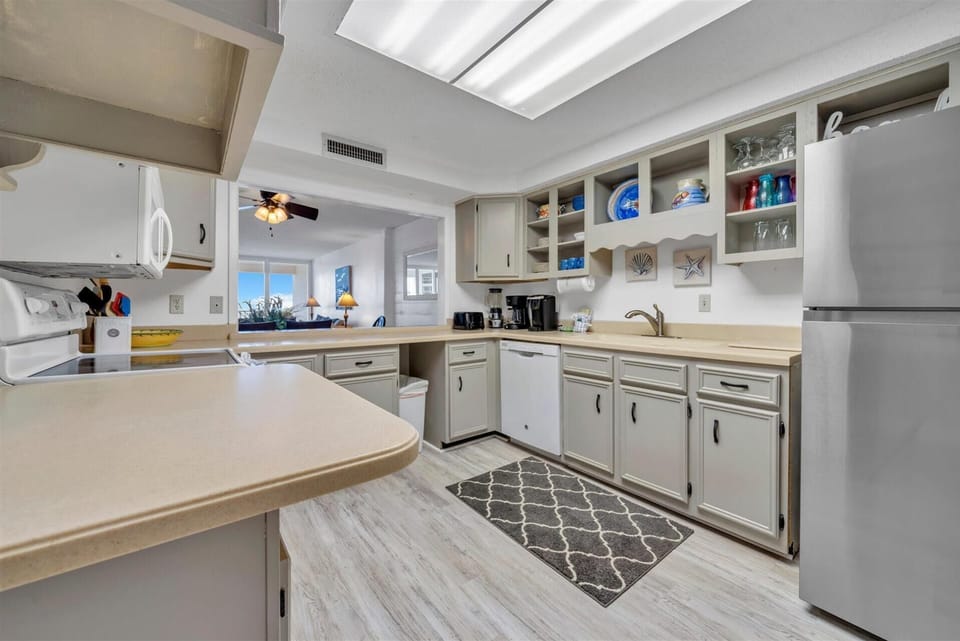 Your spacious kitchen features everything you need - dishwasher, microwave, coffee maker, and ocean views through the window.