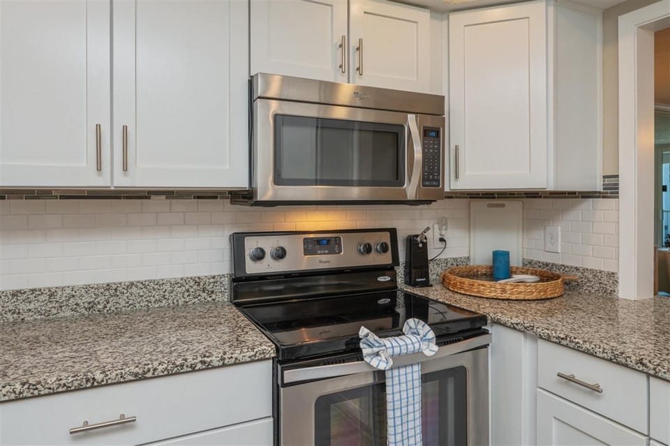 Your modern kitchen features stainless steel appliances and granite countertops, creating the perfect space for preparing delicious meals.