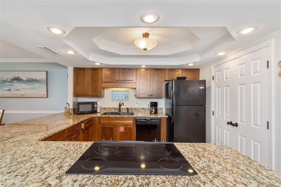 You'll love preparing meals in this fully equipped kitchen with granite countertops, modern appliances, and elegant recessed lighting throughout.