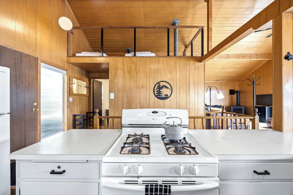 Kitchen with loft above and living room beyond
