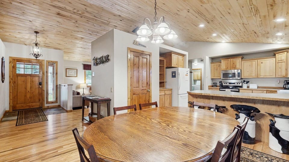 Open concept dining and kitchen with living room beyond