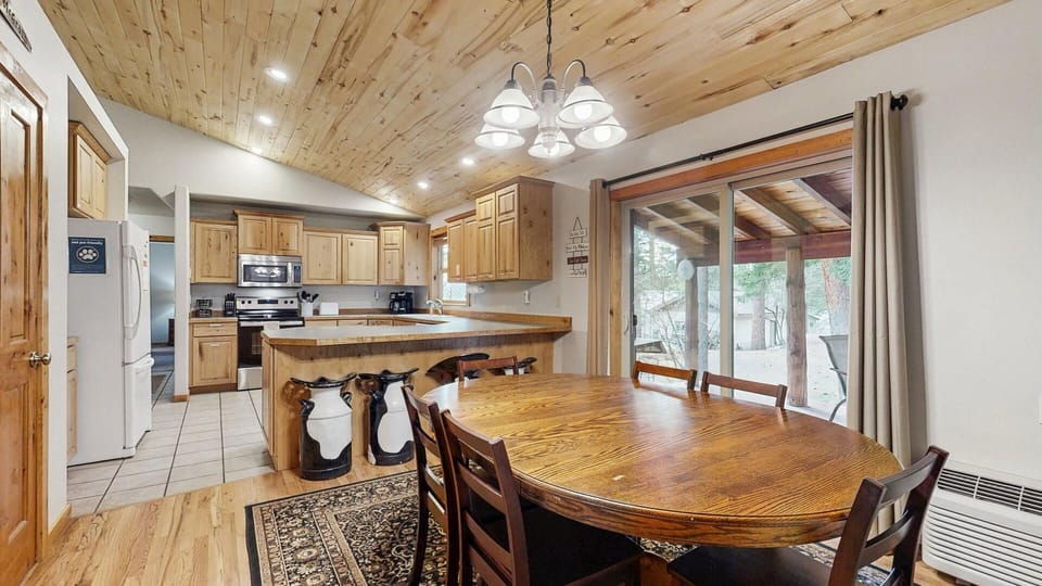 Dining room, with kitchen and back deck beyond