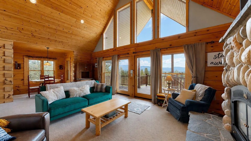 Living room, stone fireplace, mountain views