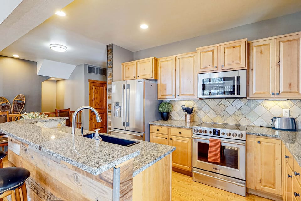Spacious kitchen island anchors this gourmet kitchen, perfect for preparing meals at Tamarack Chalet.
