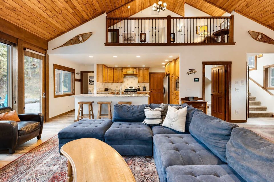 Open concept living with loft above and patio access to Payette River to the left