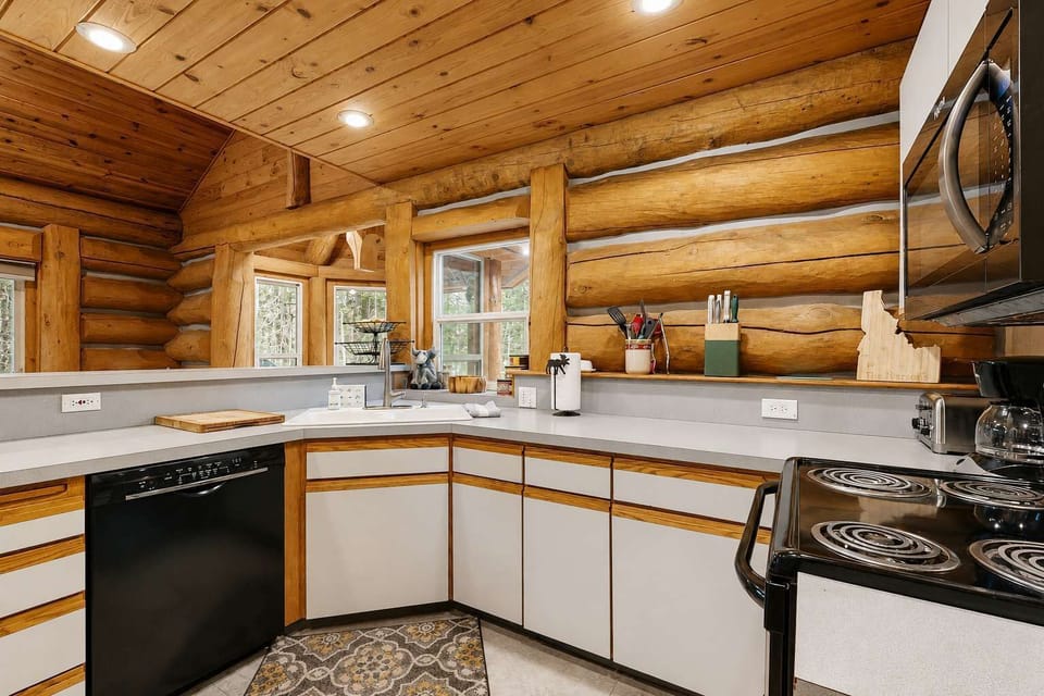 Kitchen with stainless steel appliances and dining space beyond