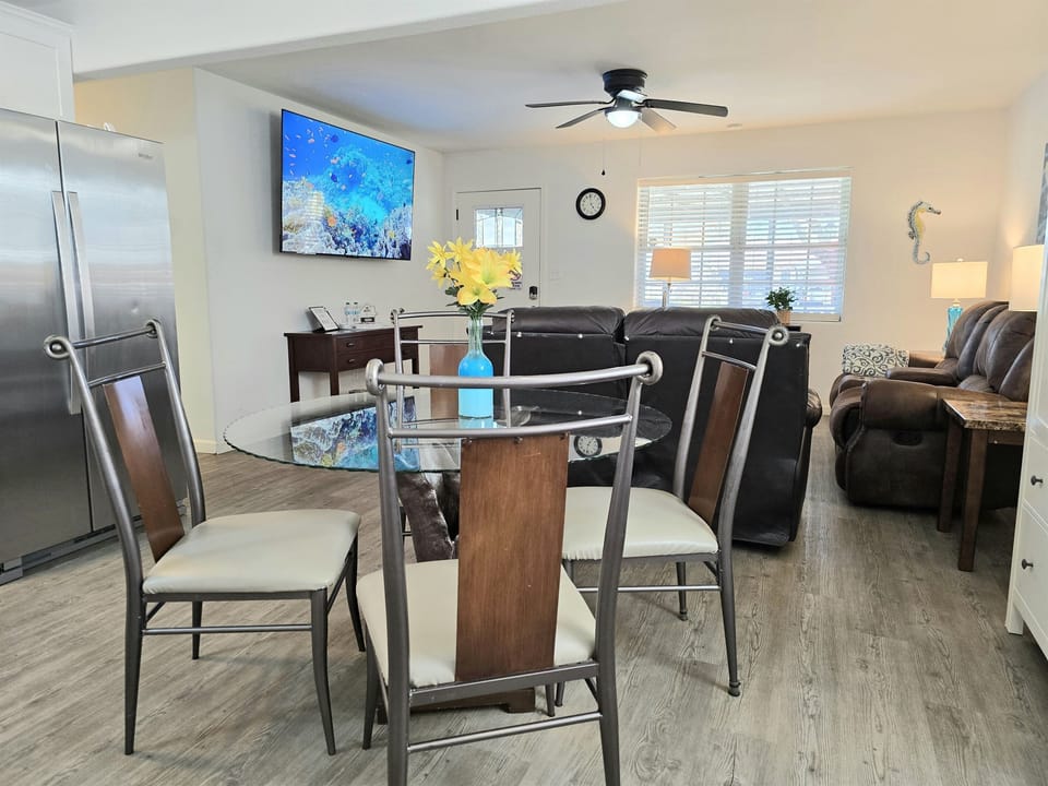 The kitchen and living room are adjacent and the big TV turns toward the kitchen if you wanted to eat dinner and watch a movie from the table. 