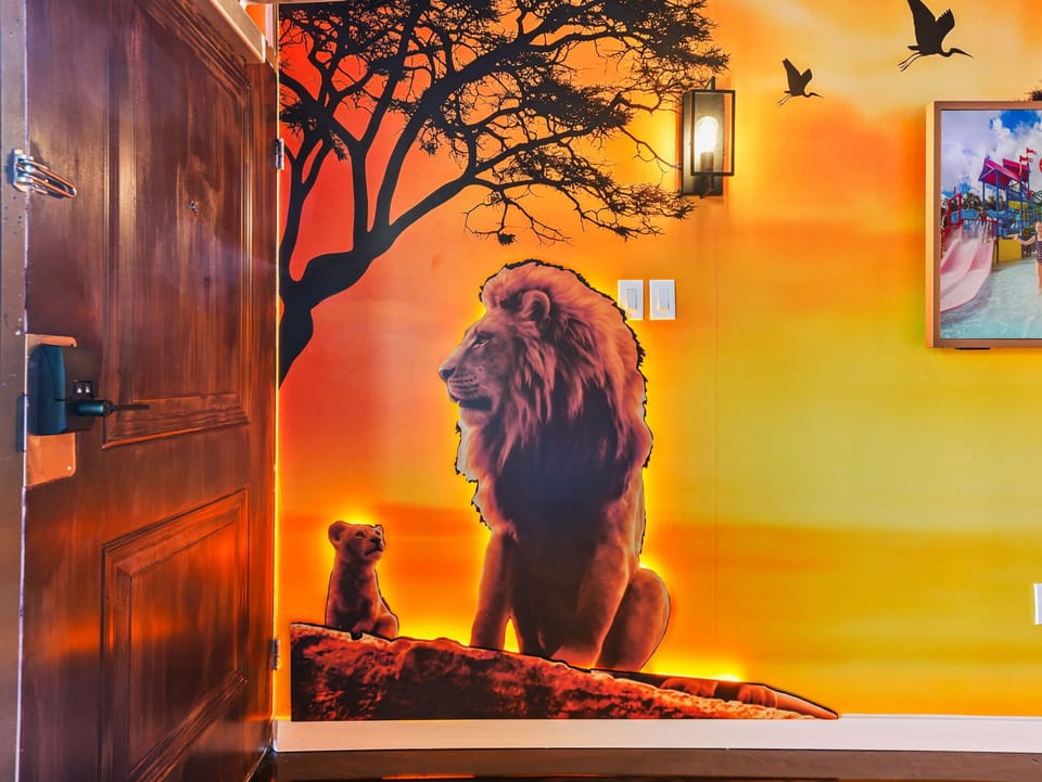 Sunset-themed wall art featuring lions adds a warm, wildlife-inspired touch to the entryway.