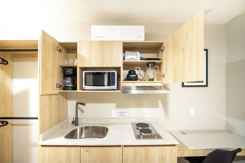 Comfort Room, Patio, Courtyard View | Minibar, in-room safe, desk, laptop workspace