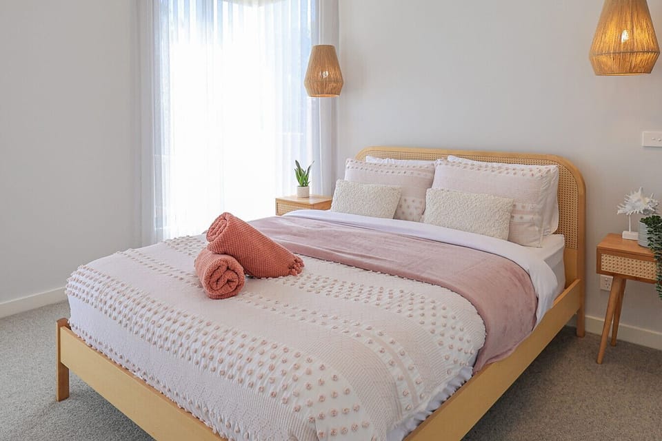 Comfortable bedroom with modern styling, plush bed, and ambient lighting