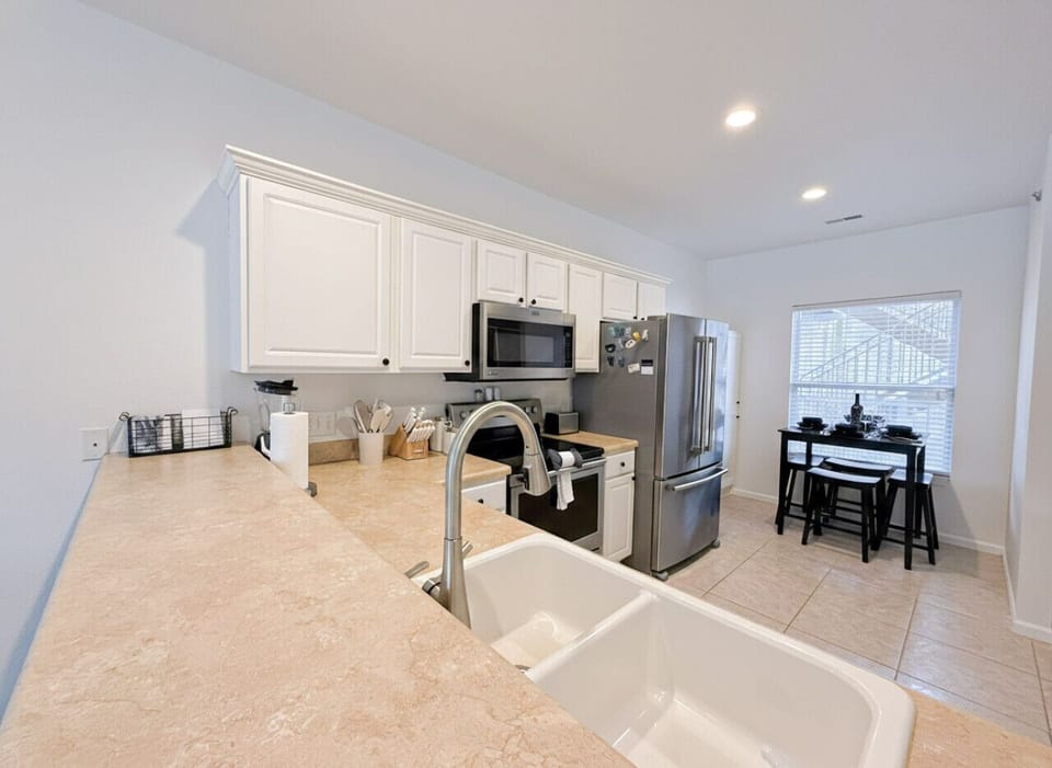 Fully equipped lakefront condo kitchen at Lake of the Ozarks with stainless steel appliances, spacious countertops, and dining area—perfect for a comfortable and convenient Ozarks vacation rental stay.