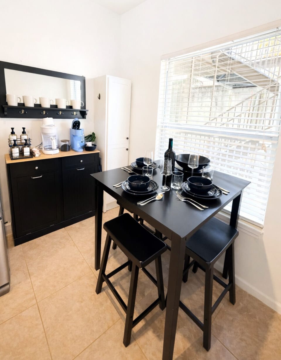 Modern dining area with coffee bar in this Lake of the Ozarks lakefront condo, fully stocked for meals and morning brews—ideal for a comfortable and convenient Ozarks vacation rental stay.
