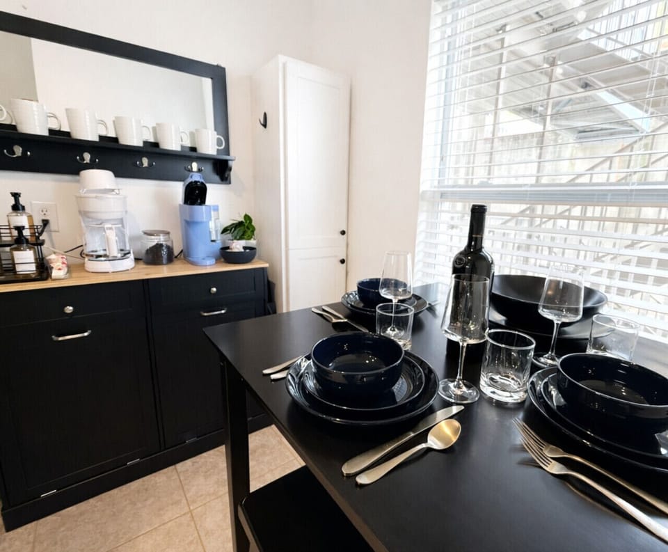 Modern dining area with coffee bar in this Lake of the Ozarks lakefront condo, fully stocked for meals and morning brews—ideal for a comfortable and convenient Ozarks vacation rental stay.