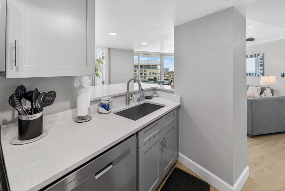 Full dishwasher alongside the sink in kitchen