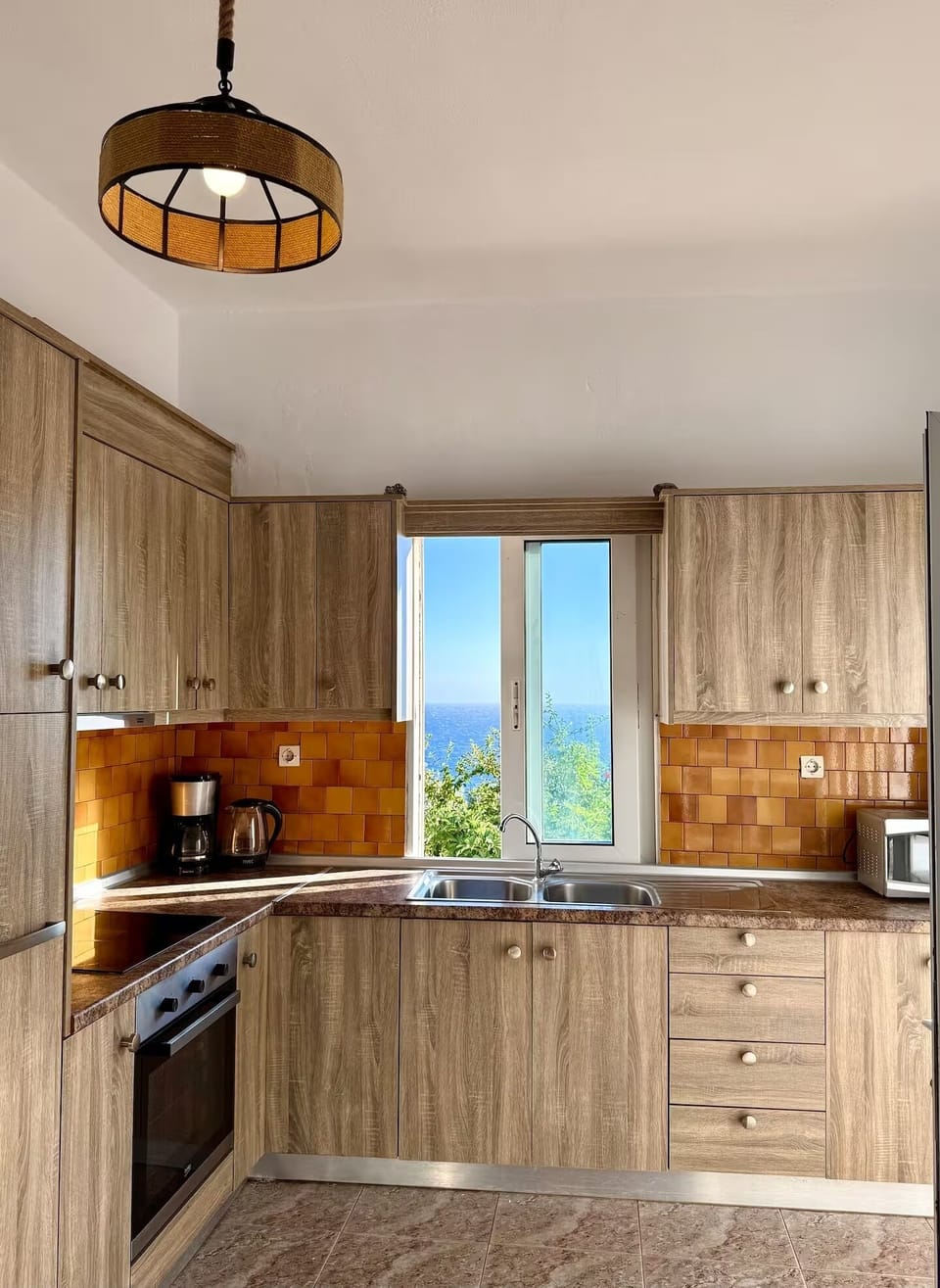 Fully equipped large kitchen with window overlooking the sea.