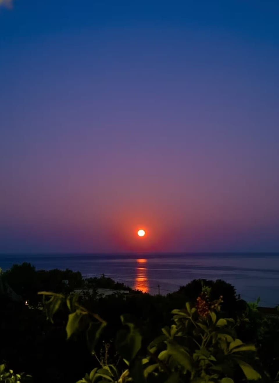 Patio view of red full moon. 
