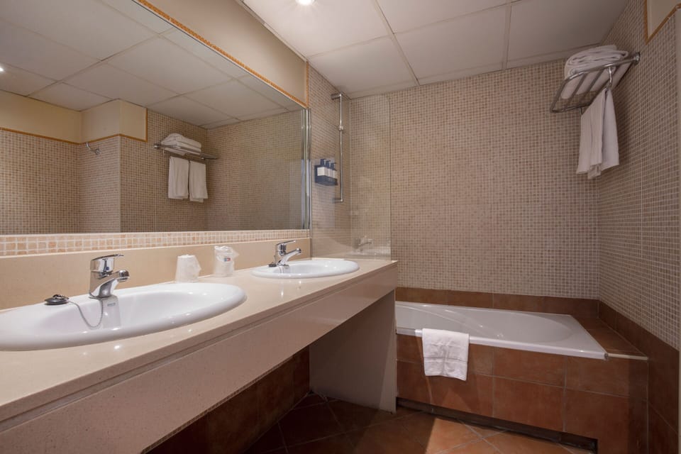 Deep soaking tub, designer toiletries, hair dryer, towels