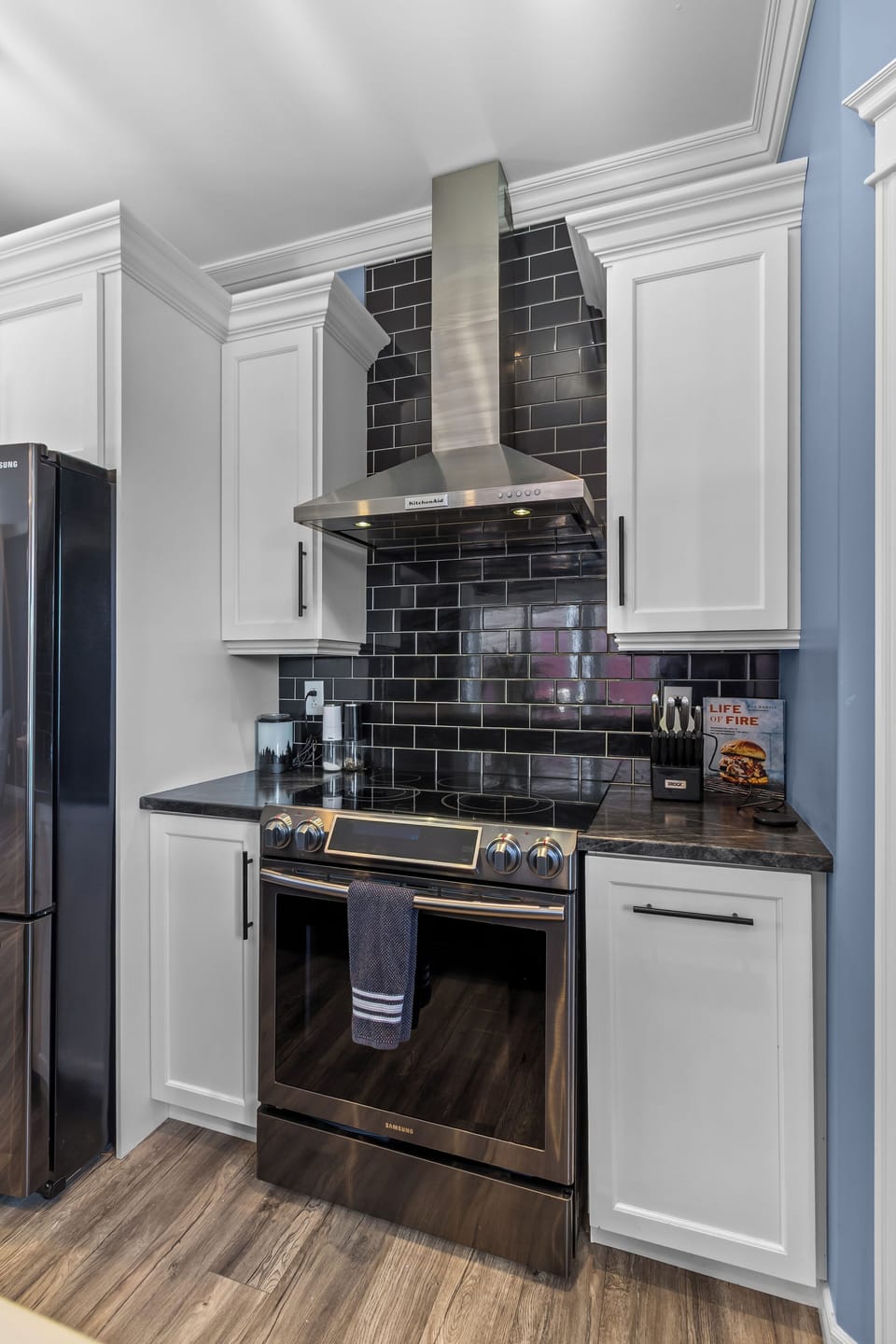 Fully equipped modern kitchen with stainless steel appliances.